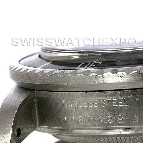 This close-up shot of the Rolex Vintage Collection 1665 Men's Stainless Steel  1665 Men's Stainless Steel  watch shows part of its stainless steel casing and bezel with visible serial number.