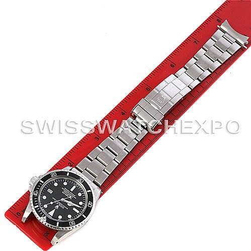 The watch, a Rolex Vintage Collection 1665 Men's Stainless Steel  1665 Men's Stainless Steel  model, is shown from a top-down angle with the face, bracelet, and clasp extended along a red ruler.