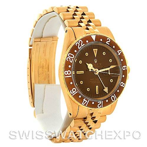 The image shows a side angle of the Rolex Vintage Collection 1675 Men's Yellow Gold Brown Dial 1675 Men's Yellow Gold Brown Dial watch, highlighting the watch face, bezel, and bracelet.