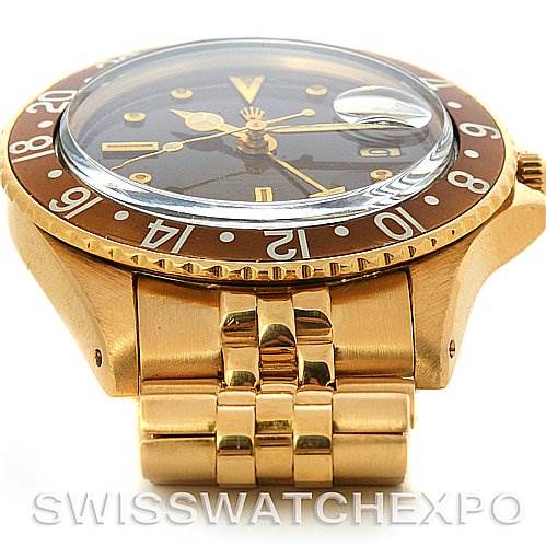 This image shows a side view of a Rolex Vintage Collection 1675 Men's Yellow Gold Brown Dial 1675 Men's Yellow Gold Brown Dial watch, highlighting its gold case, bezel, and part of the bracelet.