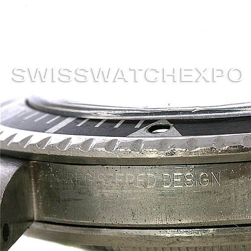Close-up view of the side of a Rolex Vintage Collection 5513 Men's Stainless Steel Black Dial 5513 Men's Stainless Steel Black Dial watch, highlighting the bezel and case with "REGISTERED DESIGN" engraving.