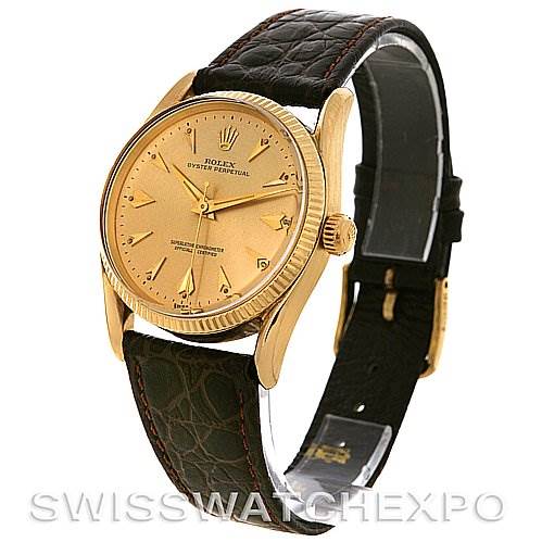The image shows a side view of the Rolex Vintage Collection 1011 Men's Yellow Gold Champagne Dial 1011 Men's Yellow Gold Champagne Dial watch, highlighting the gold case, dial, crown, and black leather strap.