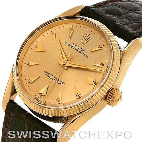This image shows a Rolex Vintage Collection 1011 Men's Yellow Gold Champagne Dial 1011 Men's Yellow Gold Champagne Dial watch at an angle highlighting its gold dial, bezel, crown, and leather strap.
