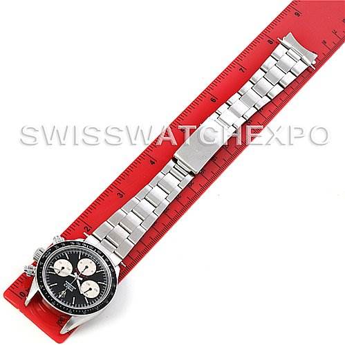 The image shows the full view of a Rolex Vintage Collection 6263 Men
s Stainless Steel Black Dial 6263 Men
s Stainless Steel Black Dial watch with its silver bracelet and black dial, alongside a red ruler for scale.