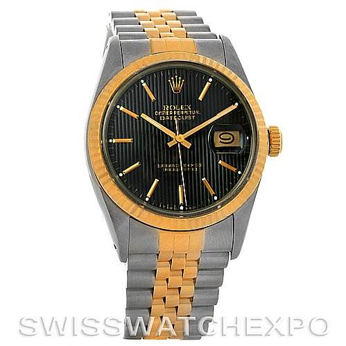 The image shows a Rolex Vintage Collection 16013 Men
s Stainless Steel Black Dial 16013 Men
s Stainless Steel Black Dial Datejust watch from the front, highlighting its gold bezel, black dial, date window, and two-tone bracelet.