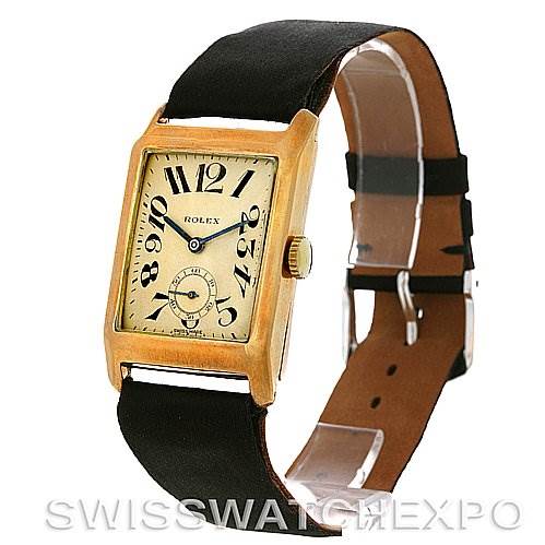 The image shows a front view of a Rolex Vintage Collection Men's Yellow Gold Beige Dial Men's Yellow Gold Beige Dial model watch with a rectangular face, black strap, and gold casing.