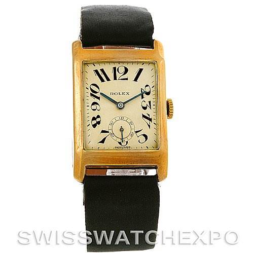 The image shows a front view of the Rolex Vintage Collection Men's Yellow Gold Beige Dial Men's Yellow Gold Beige Dial watch, highlighting its rectangular face, gold case, and black strap.