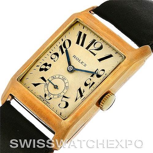 This image shows a Vintage Collection model by Rolex from an angled top view, highlighting the watch face, gold case, and black strap.