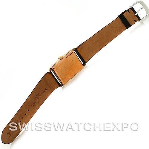 The image shows the back of a Rolex Vintage Collection Men's Yellow Gold Beige Dial Men's Yellow Gold Beige Dial watch, showcasing its leather strap and metal buckle.