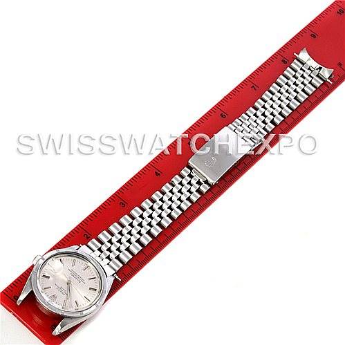 The image shows a Rolex Vintage Collection 15010 Men's Stainless Steel White Dial 15010 Men's Stainless Steel White Dial watch laid flat, displaying its face and metal bracelet alongside a red ruler.