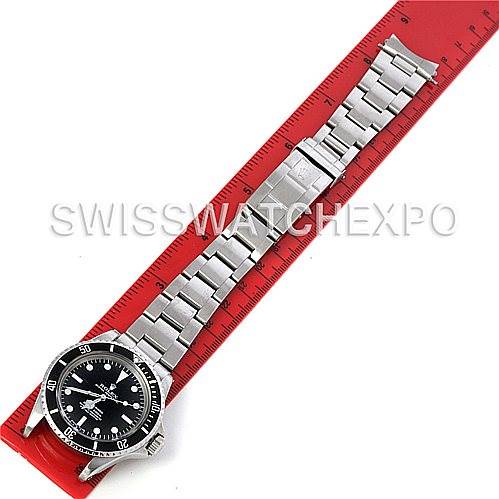 The image shows a Rolex Vintage Collection 1512 Men
s Stainless Steel  1512 Men
s Stainless Steel  watch laid flat on a red ruler, displaying the face, bezel, and metal bracelet.