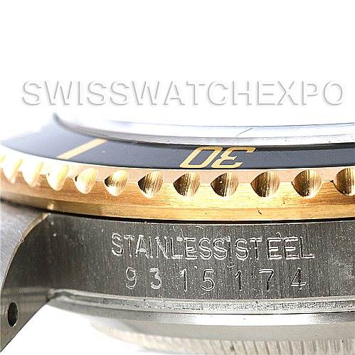 The image shows a close-up of the Rolex Vintage Collection 16803 Men's Steel and Gold (two tone) Black Dial 16803 Men's Steel and Gold (two tone) Black Dial watch's stainless steel case and gold bezel, focusing on the serial number.