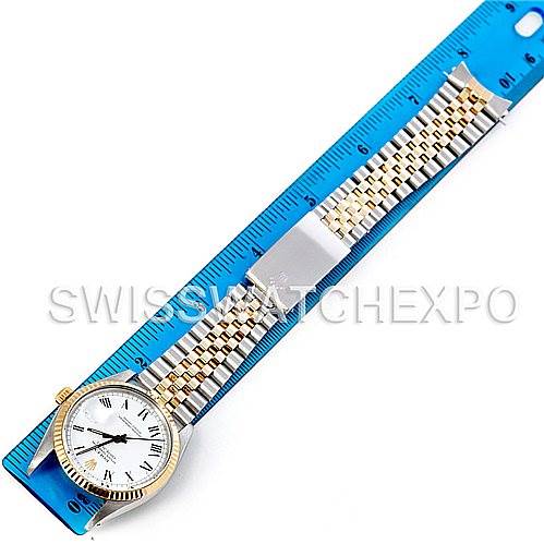 The Rolex Vintage Collection 16013 Men's Stainless Steel White Dial 16013 Men's Stainless Steel White Dial watch is shown from a top-down angle with its full bracelet extended along a blue ruler.