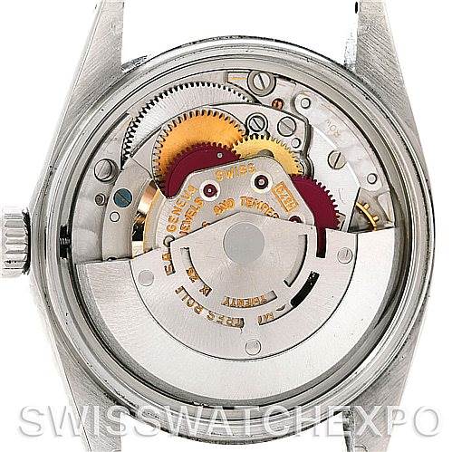 The image shows the open case back of a Vintage Collection Rolex watch, highlighting its intricate internal mechanical movement.