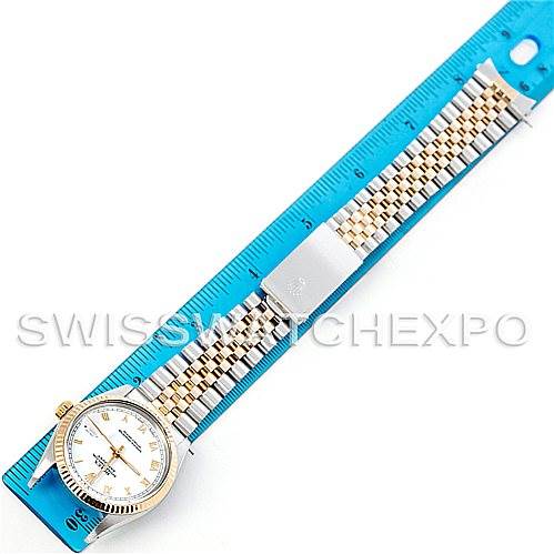 The image shows a top view of a Rolex Vintage Collection 16013 Men's Stainless Steel White Dial 16013 Men's Stainless Steel White Dial model watch, including its face and metal bracelet laid next to a ruler.