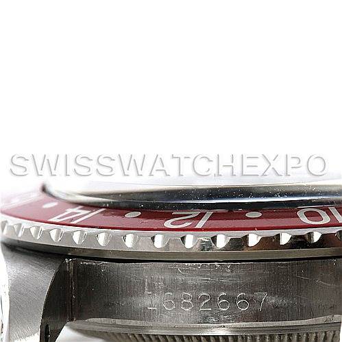 The image shows a side angle of a Rolex Vintage Collection 1675 Men's Stainless Steel Black Dial 1675 Men's Stainless Steel Black Dial model, focusing on the bezel, part of the dial, and case with a visible serial number.