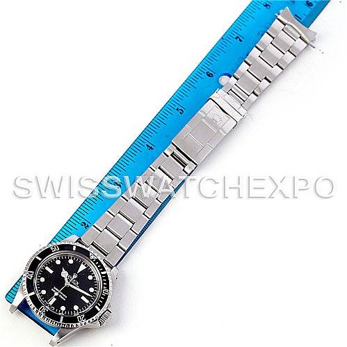 The image shows a Rolex Vintage Collection 5513 Men's Stainless Steel Black Dial 5513 Men's Stainless Steel Black Dial watch from a top-down angle, highlighting its bracelet and front dial against a ruler.