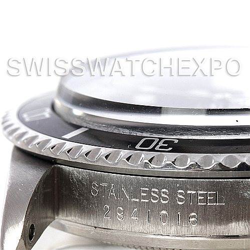 The image shows a close-up side view of the bezel and crown area of a Rolex Vintage Collection 1680 Men's Stainless Steel Black Dial 1680 Men's Stainless Steel Black Dial watch, highlighting its stainless steel material and part of the bezel with numerals.