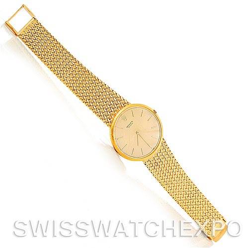 This image shows the full length of a Rolex Vintage Collection 9577 Men's Yellow Gold Champagne Dial 9577 Men's Yellow Gold Champagne Dial watch, highlighting its gold mesh strap and round dial at a top-view angle.