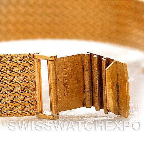 This image shows a close-up of the clasp and part of the gold bracelet of a Vintage Collection Rolex watch.