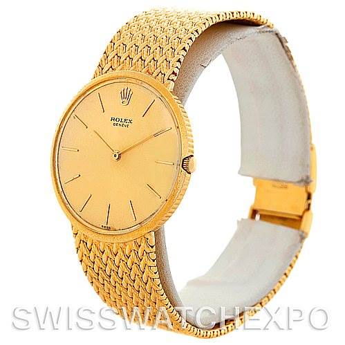 This Rolex Vintage Collection 9577 Men's Yellow Gold Champagne Dial 9577 Men's Yellow Gold Champagne Dial watch is shown at an oblique angle highlighting the dial, hands, crown, and textured gold band.