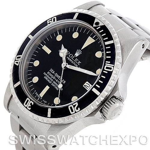 The image shows a side angle of the Rolex Vintage Collection 1665 Men's Stainless Steel  1665 Men's Stainless Steel  Sea-Dweller, highlighting its bezel, crown, and watch face.