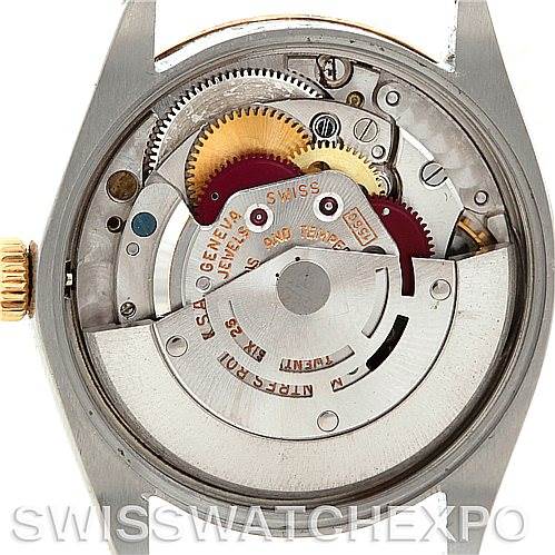 The image shows the back side of a Rolex Vintage Collection 1002 Men's Steel and Gold (two tone) Silver Dial 1002 Men's Steel and Gold (two tone) Silver Dial model, revealing the intricate movement and gears inside the watch.