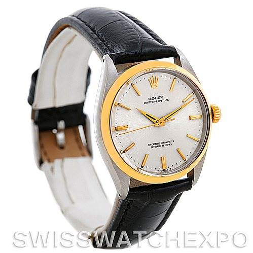 The image shows a Rolex Vintage Collection 1002 Men's Steel and Gold (two tone) Silver Dial 1002 Men's Steel and Gold (two tone) Silver Dial watch at an angle highlighting its face, bezel, crown, and leather strap.