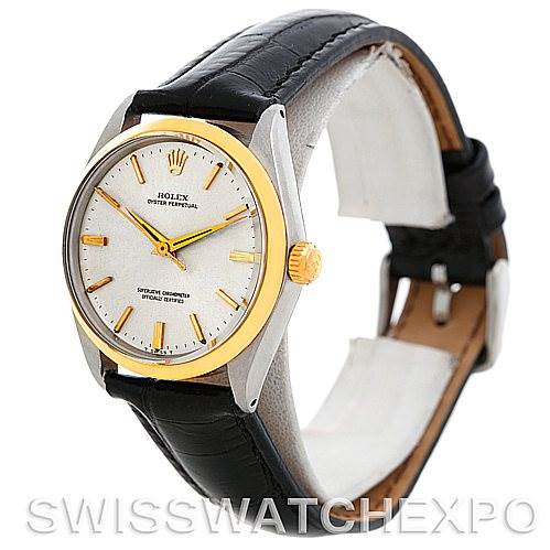 This angled view shows the face, bezel, and strap of a black Vintage Collection Rolex Oyster Perpetual watch.
