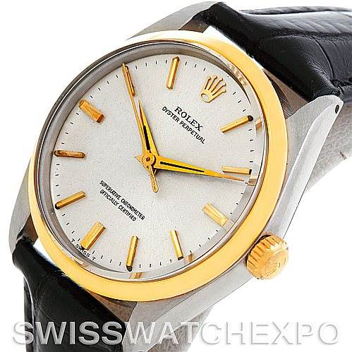 The image shows a close-up view of a Rolex Vintage Collection 1002 Men's Steel and Gold (two tone) Silver Dial 1002 Men's Steel and Gold (two tone) Silver Dial watch, featuring its face, crown, and part of the leather strap.