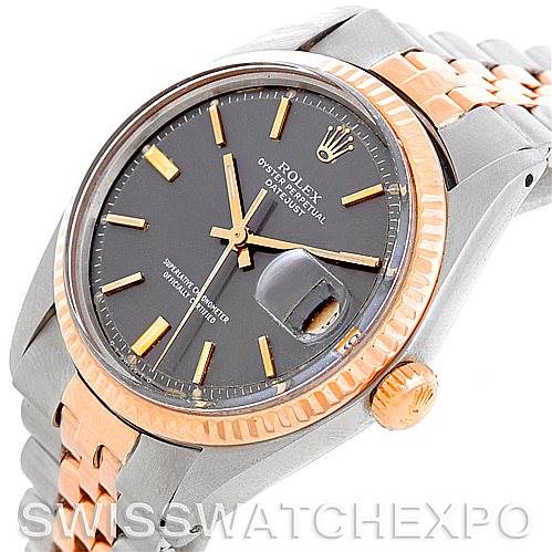 The image shows a Rolex Vintage Collection 1601 Men's Steel and Gold (two tone) Grey Dial 1601 Men's Steel and Gold (two tone) Grey Dial watch at a slight angle, featuring a two-tone bracelet, a black dial, and the signature date magnifier.