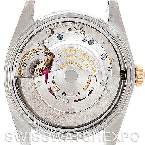 The image shows the internal mechanism and movement of a Vintage Collection Rolex watch.