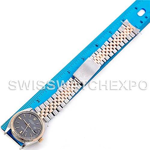 The image shows a Rolex Vintage Collection 1601 Men's Steel and Gold (two tone) Grey Dial 1601 Men's Steel and Gold (two tone) Grey Dial watch laid flat next to a blue ruler for scale.