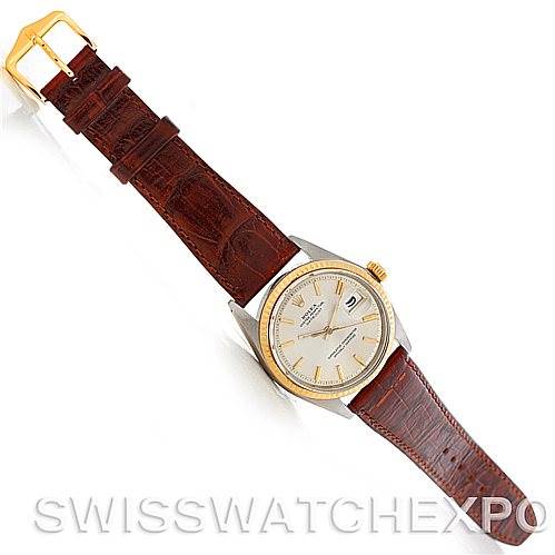 The image shows a Rolex Vintage Collection 1601 Men's Stainless Steel Silver Dial 1601 Men's Stainless Steel Silver Dial watch with a brown leather strap, gold bezel, and white dial, viewed from a top-down angle.