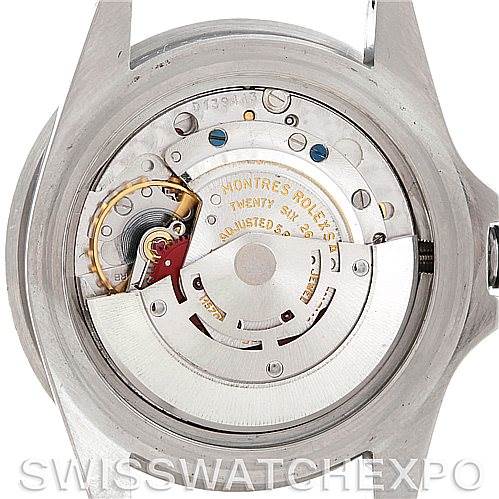 The image shows the inner mechanism of a Vintage Collection Rolex watch from a back angle with the case back removed.