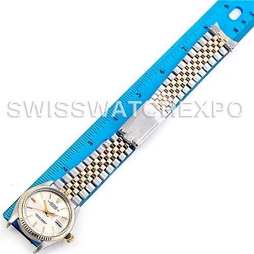 The image shows the Rolex Vintage Collection 1601 Men's Steel and Gold (two tone) Silver Dial 1601 Men's Steel and Gold (two tone) Silver Dial watch laid flat with a blue ruler for scale, displaying the face and bracelet details.