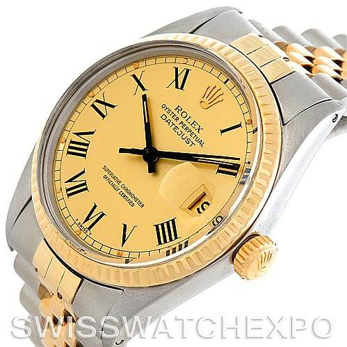 The image shows the face and part of the bracelet of the Vintage Collection Rolex Datejust with a yellow gold dial and Roman numerals.