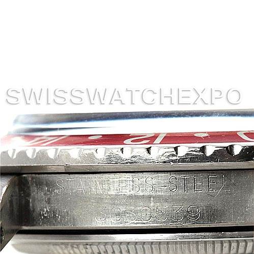 This image shows a close-up of the side and bezel of a Rolex Vintage Collection 1675 Men's Stainless Steel Black Dial 1675 Men's Stainless Steel Black Dial watch, displaying the "STAINLESS STEEL" engraving and part of the serial number.
