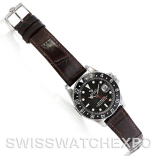 The image displays a full view of a Rolex Vintage Collection 1675 Men's Stainless Steel Black Dial 1675 Men's Stainless Steel Black Dial watch, showcasing the dial, bezel, and brown leather strap from a top-down angle.