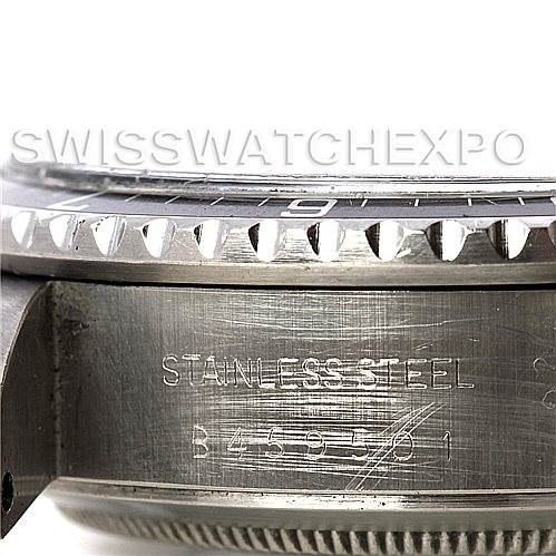 This image shows a close-up of the bezel and case side of a Vintage Collection model by Rolex, highlighting the stainless steel engraving and serial number.