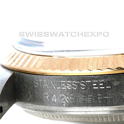 This image shows a close-up of the side of a Rolex Vintage Collection 5701 Men
s Stainless Steel Champagne Dial 5701 Men
s Stainless Steel Champagne Dial watch, focusing on the engraved serial number and the bezel.