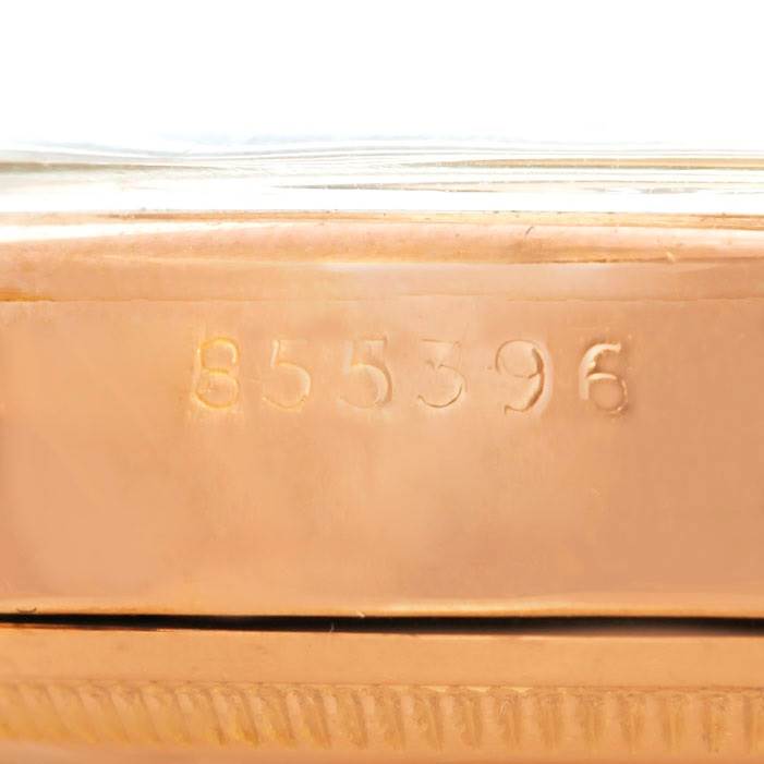 This photo shows a close-up view of the serial number engraving on the casing of a Rolex Vintage Collection 6090 Men's Rose Gold Silver Dial 6090 Men's Rose Gold Silver Dial watch.