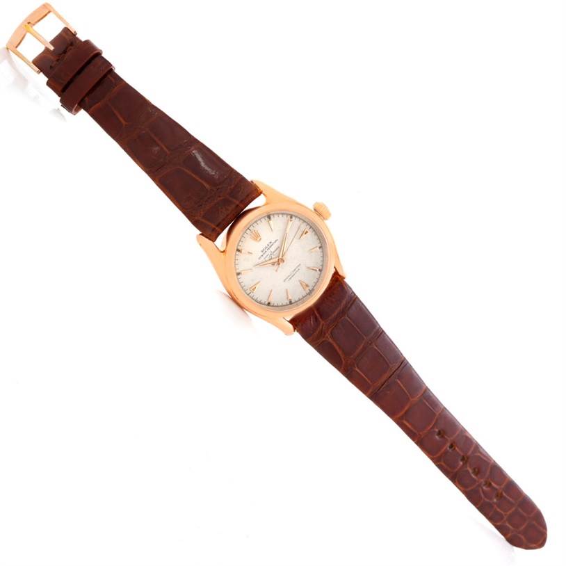 The Rolex Vintage Collection 6090 Men's Rose Gold Silver Dial 6090 Men's Rose Gold Silver Dial watch is shown from a top-down angle, displaying the face, bezel, crown, and leather strap.