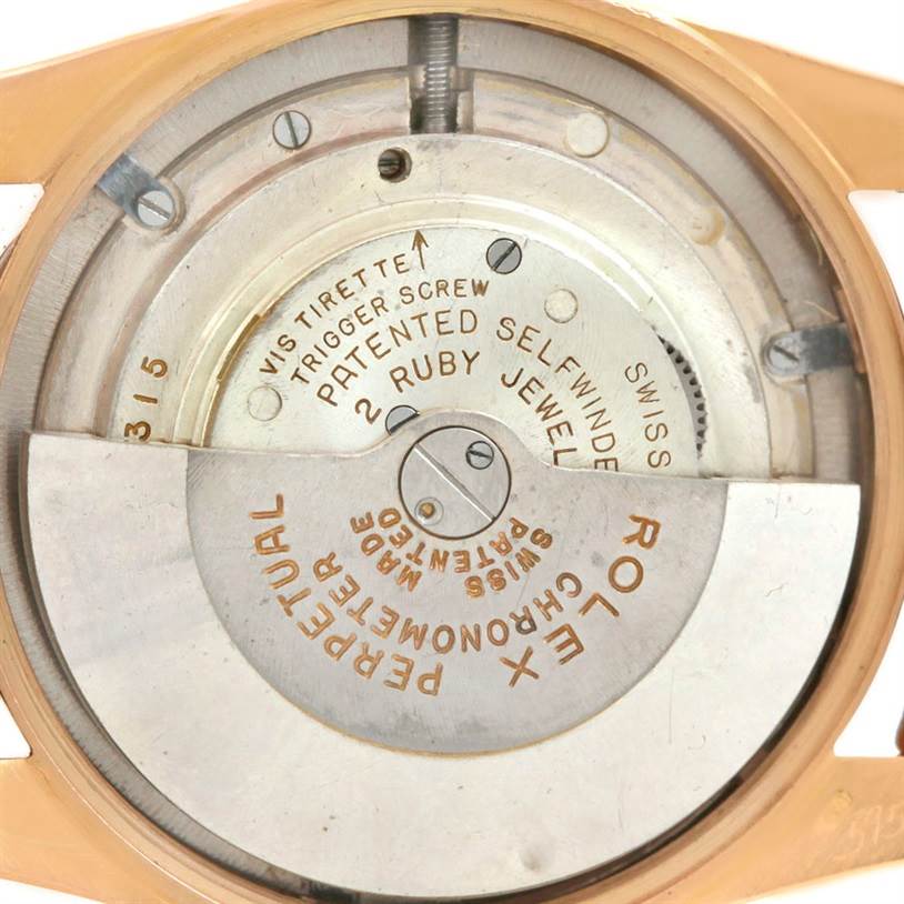 This image shows the internal mechanism of a Rolex Vintage Collection 6090 Men's Rose Gold Silver Dial 6090 Men's Rose Gold Silver Dial watch from a rear angle, highlighting the rotor and self-winding components.