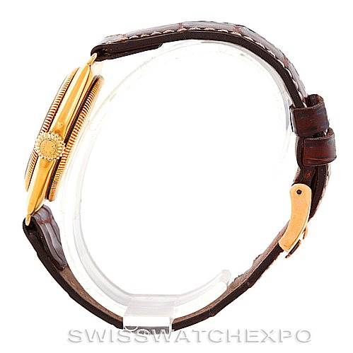 The image shows a side view of the Rolex Vintage Collection 679 Men's Yellow Gold Silver Dial 679 Men's Yellow Gold Silver Dial watch, highlighting the crown and leather strap.