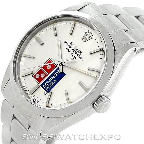 This image shows a close-up of a Vintage Collection Rolex watch, focusing on the face, bezel, and part of the metal band.