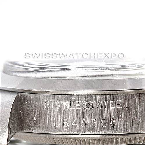 The image shows a close-up angle of the side of a Vintage Collection Rolex watch, highlighting the stainless steel case and serial number.