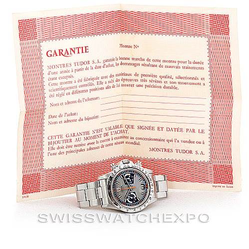 The image shows a front view of a Vintage Collection Rolex watch placed in front of an open warranty certificate.