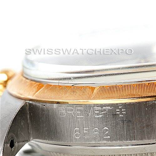 The image shows a close-up angle of the side of a Rolex Vintage Collection 6582 Men's Steel and Gold (two tone) Silver Dial 6582 Men's Steel and Gold (two tone) Silver Dial watch, highlighting the bezel and part of the watch case with serial number 6582.
