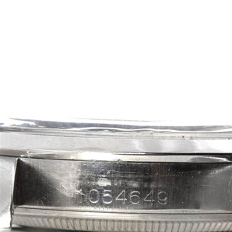 The image shows a close-up side view of the casing of a Rolex Vintage Collection 1016 Men's Stainless Steel Black Dial 1016 Men's Stainless Steel Black Dial watch with the serial number visible.